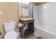 Cozy bathroom with granite countertop, a mirror with lights, and a toilet at 6900 N Ocean Blvd. # 222, Myrtle Beach, SC 29572