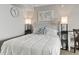 Well-lit bedroom with neutral tones, a comfortable bed, and a decorative world map at 6900 N Ocean Blvd. # 222, Myrtle Beach, SC 29572