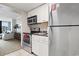 Well-equipped kitchenette with stainless appliances and view into adjacent living space at 6900 N Ocean Blvd. # 222, Myrtle Beach, SC 29572