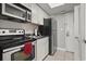 Compact kitchen featuring modern appliances, white cabinetry, and functional layout at 6900 N Ocean Blvd. # 222, Myrtle Beach, SC 29572