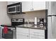 Efficient kitchen with stainless steel appliances, white cabinets, and dark countertop at 6900 N Ocean Blvd. # 222, Myrtle Beach, SC 29572