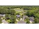 Aerial view of homes, golf course, pond, and surrounding mature trees at 7005 Wellesley Ct., Murrells Inlet, SC 29576