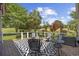 Spacious back deck with seating and a view of the lush green surroundings and a golf course at 7005 Wellesley Ct., Murrells Inlet, SC 29576