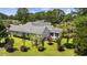 Aerial view of the home showcasing the landscaped backyard with a deck, mature trees, and green lawn at 7005 Wellesley Ct., Murrells Inlet, SC 29576