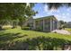 Spacious backyard with a sunroom, a patio, green grass, and various plantings at 7005 Wellesley Ct., Murrells Inlet, SC 29576