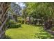 Lush backyard featuring green grass, various trees, shrubs, and shade at 7005 Wellesley Ct., Murrells Inlet, SC 29576
