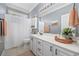 Bright bathroom with white cabinets, a neutral shower curtain, and a large mirror over the sink at 7005 Wellesley Ct., Murrells Inlet, SC 29576