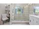 Bright bathroom features a large glass shower with pebble flooring accents and a window view at 7005 Wellesley Ct., Murrells Inlet, SC 29576