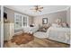 Inviting bedroom with two beds, hardwood floors, and a large window for plenty of sunlight at 7005 Wellesley Ct., Murrells Inlet, SC 29576