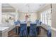 Elegant dining room featuring a large wooden table with blue upholstered chairs at 7005 Wellesley Ct., Murrells Inlet, SC 29576