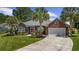 Charming brick home with well-maintained landscaping, palm trees, and a paved driveway at 7005 Wellesley Ct., Murrells Inlet, SC 29576