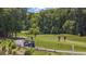 Golf course view of players preparing to tee off, golf carts, and natural foliage at 7005 Wellesley Ct., Murrells Inlet, SC 29576
