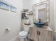 Charming half bath with rustic-framed mirror and a unique vessel sink on a wood-style vanity at 7005 Wellesley Ct., Murrells Inlet, SC 29576