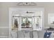 A large opening with sliding barn doors offers a view from one stylish living space to another at 7005 Wellesley Ct., Murrells Inlet, SC 29576