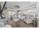 Bright and airy living room featuring hardwood floors, fireplace, and a sectional sofa at 7005 Wellesley Ct., Murrells Inlet, SC 29576
