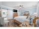 Spacious main bedroom with light blue walls, wood floors, and access to an en-suite bathroom at 7005 Wellesley Ct., Murrells Inlet, SC 29576