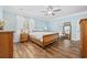 Serene main bedroom featuring hardwood floors, a large window, and elegant furnishings at 7005 Wellesley Ct., Murrells Inlet, SC 29576