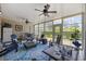 Cozy sunroom with ample seating, ceiling fans, and views of the outdoors at 7005 Wellesley Ct., Murrells Inlet, SC 29576