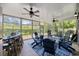 Inviting sunroom with comfortable seating, ceiling fans, and large windows showcasing the beautiful landscape at 7005 Wellesley Ct., Murrells Inlet, SC 29576