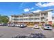 Multi-story condominium with balconies and well-maintained parking area and landscaping at 701 Salleyport Dr. # 1110, Myrtle Beach, SC 29579