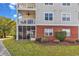 Multi-story condominium building with balconies and patios, brick accents, lawn, and mature landscaping at 701 Salleyport Dr. # 1110, Myrtle Beach, SC 29579