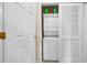 A stacked white washer and dryer sit behind a set of folding closet doors at 701 Salleyport Dr. # 1110, Myrtle Beach, SC 29579