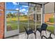Screened-in patio with tiled floors, with the view of the common grounds and neighboring buildings at 701 Salleyport Dr. # 1110, Myrtle Beach, SC 29579