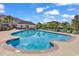 Community pool with lounge chairs and umbrellas, with surrounding buildings and blue sky at 701 Salleyport Dr. # 1110, Myrtle Beach, SC 29579