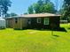 The backyard features a brick exterior and lush lawn at 704 W Alder St., Andrews, SC 29510
