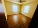 Bright bedroom featuring ceiling fan, neutral walls, and laminate flooring at 704 W Alder St., Andrews, SC 29510