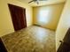 Empty bedroom with ceiling fan, closet with shutter doors, and natural light at 704 W Alder St., Andrews, SC 29510