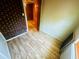 Hallway featuring brick wall, paneled walls, wood flooring, and wood trim at 704 W Alder St., Andrews, SC 29510