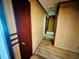 Hallway featuring paneled walls, wood flooring, and wood trim at 704 W Alder St., Andrews, SC 29510