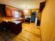 Well-lit kitchen featuring wood cabinets, matching island, laminate floors, and stainless steel oven at 704 W Alder St., Andrews, SC 29510