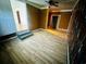 Living room featuring light wood laminate floors, ceiling fan, and three points of entry at 704 W Alder St., Andrews, SC 29510