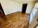 Bright living room featuring new laminate floors, fresh paint, and a convenient electrical outlets at 704 W Alder St., Andrews, SC 29510