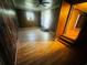 Living room featuring light wood laminate floors, ceiling fan, air conditioner, and three points of entry at 704 W Alder St., Andrews, SC 29510