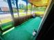 Screened porch with an artificial grass and view of the neighborhood at 704 W Alder St., Andrews, SC 29510