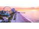 Picturesque view of the beach with a Ferris wheel and skyline at sunset at 755 Burcale Rd. # E-3, Myrtle Beach, SC 29579