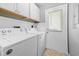 White Amana washer and dryer set is located in a laundry room with white cabinets and access to outdoors at 755 Burcale Rd. # E-3, Myrtle Beach, SC 29579