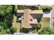 Aerial view of a house with a well-maintained roof, an outdoor patio, and a green backyard at 77 Redwing Ct., Pawleys Island, SC 29585