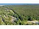 Aerial view of a neighborhood surrounded by lush forests, near a golf course and the ocean at 77 Redwing Ct., Pawleys Island, SC 29585