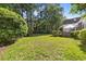 The manicured backyard features an outdoor patio, mature trees, and sprawling lawn space at 77 Redwing Ct., Pawleys Island, SC 29585