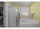 Bathroom with a glass-enclosed shower, separate jacuzzi tub and large window for natural light at 77 Redwing Ct., Pawleys Island, SC 29585