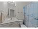Bathroom features a single sink vanity, commode and shower with blue patterned curtain at 77 Redwing Ct., Pawleys Island, SC 29585