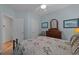 Comfortable bedroom featuring a decorative bed frame, dresser with mirror, and blue accent walls at 77 Redwing Ct., Pawleys Island, SC 29585