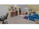Finished bonus room with comfortable seating, workspace, and media center for entertaining at 77 Redwing Ct., Pawleys Island, SC 29585