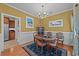 Cozy dining room featuring hardwood floors, a chandelier, and a view into the kitchen area at 77 Redwing Ct., Pawleys Island, SC 29585