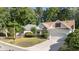 Charming home with white siding, red shutters, well-maintained landscaping, and a two-car garage at 77 Redwing Ct., Pawleys Island, SC 29585