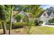 Charming home with white siding, red shutters, well-maintained landscaping, and a two-car garage at 77 Redwing Ct., Pawleys Island, SC 29585